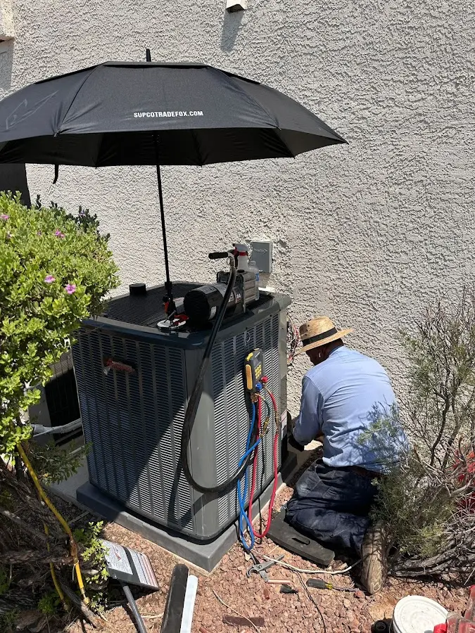 HVAC technician performing outdoor AC maintenance in Mayville